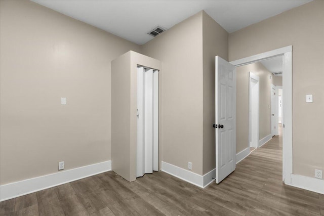 unfurnished bedroom with hardwood / wood-style flooring