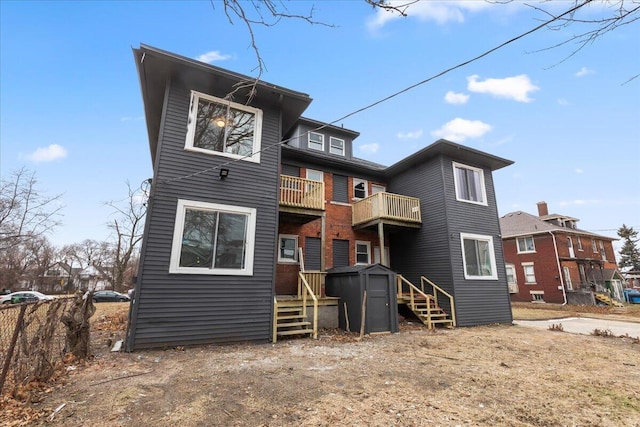 rear view of property featuring a balcony