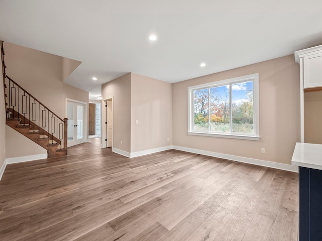 unfurnished living room with light wood-type flooring