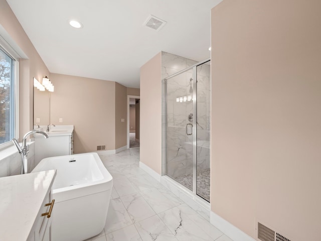 bathroom with vanity and independent shower and bath