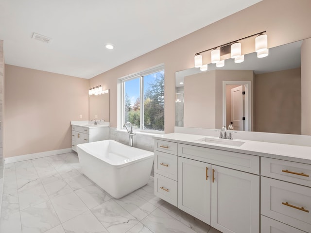 bathroom featuring vanity and a tub