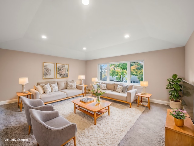 carpeted living room featuring a tray ceiling