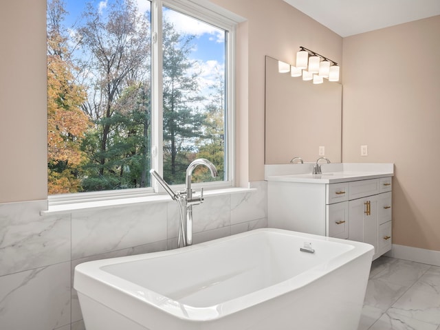 bathroom with a tub and vanity