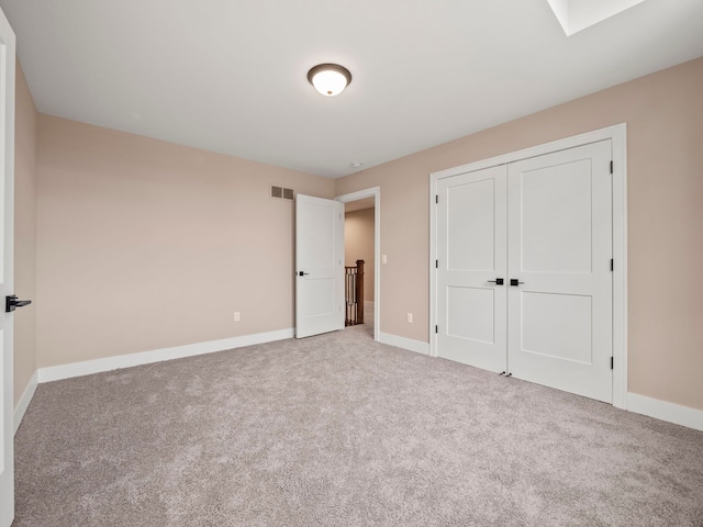 unfurnished bedroom featuring a closet and carpet floors