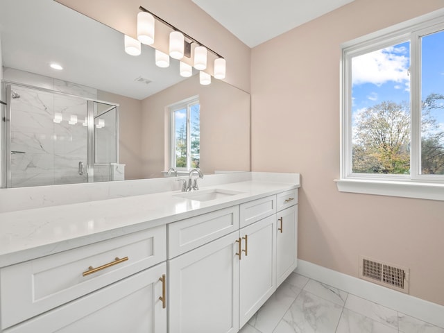 bathroom with vanity, a healthy amount of sunlight, and an enclosed shower