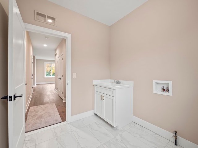 washroom with hookup for a washing machine and sink