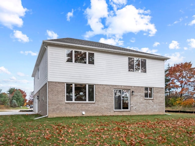 rear view of property with a lawn