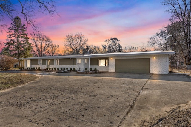 ranch-style home featuring a garage