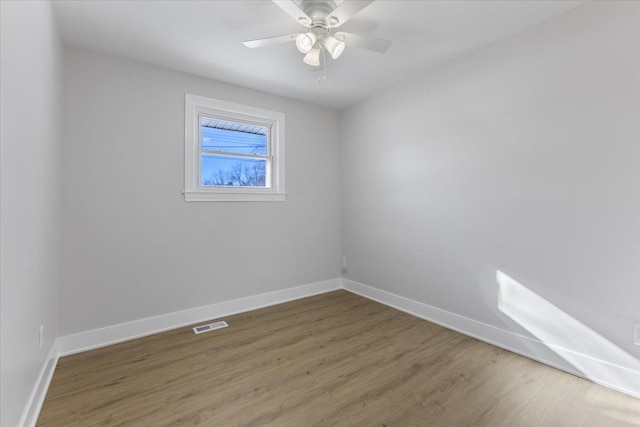 spare room featuring ceiling fan and dark hardwood / wood-style flooring