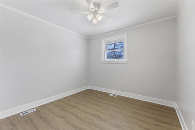 spare room with hardwood / wood-style flooring, ceiling fan, and crown molding