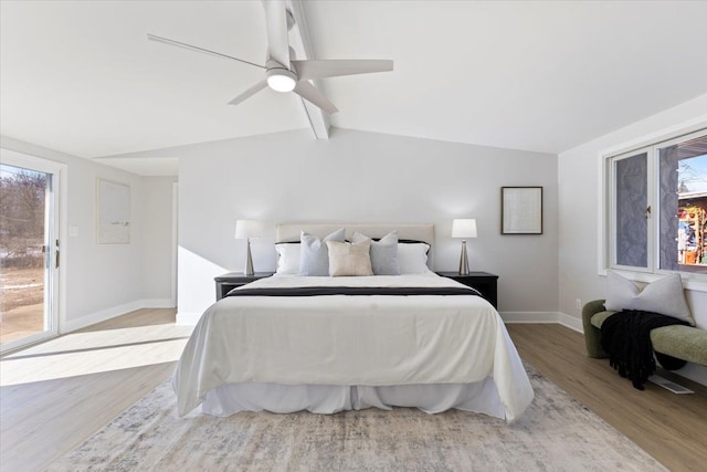 bedroom featuring light hardwood / wood-style flooring, vaulted ceiling with beams, ceiling fan, access to exterior, and multiple windows