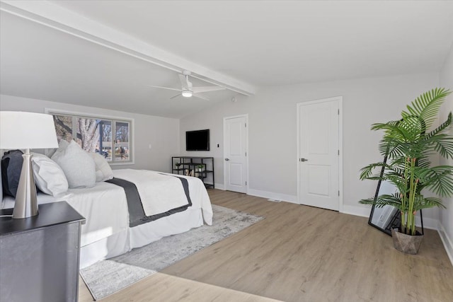 bedroom with lofted ceiling with beams, light hardwood / wood-style floors, and ceiling fan