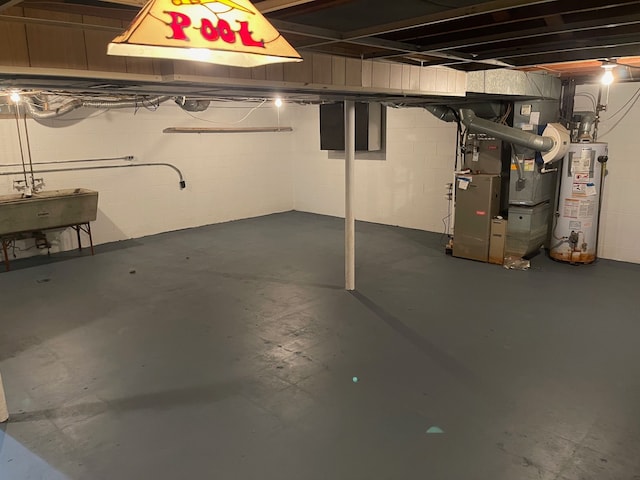 basement featuring heating unit, sink, and gas water heater