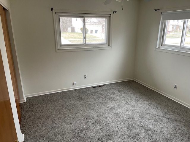 carpeted empty room featuring ceiling fan