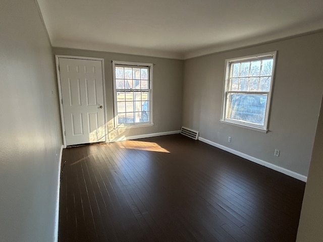 spare room featuring dark hardwood / wood-style floors