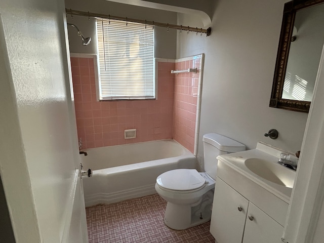 full bathroom featuring tile patterned flooring, vanity, toilet, and tiled shower / bath