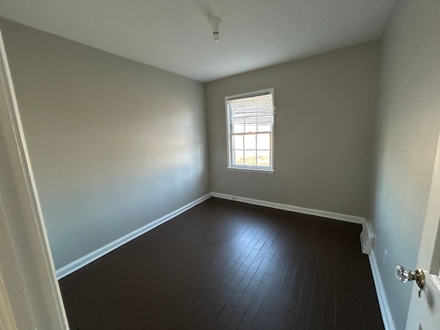 spare room featuring dark hardwood / wood-style flooring