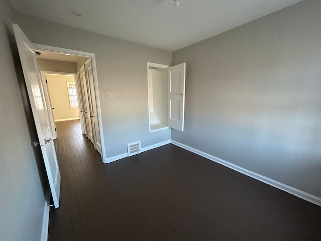 unfurnished room with dark hardwood / wood-style floors