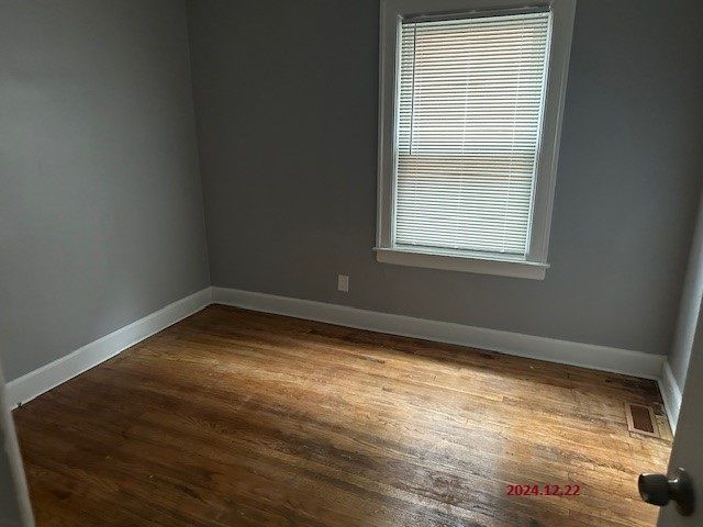 unfurnished room featuring hardwood / wood-style flooring