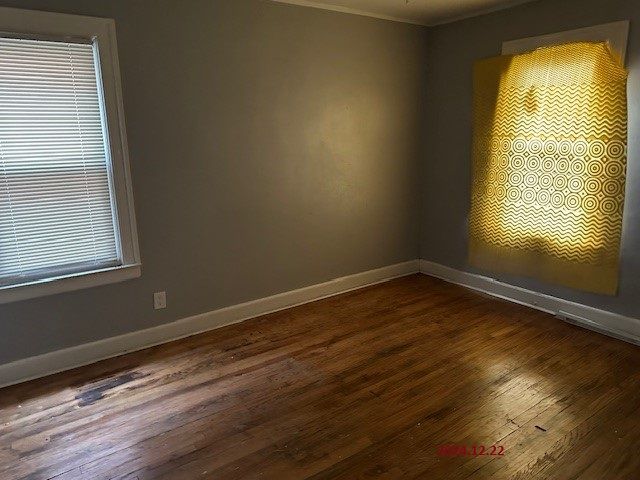 spare room featuring dark wood-type flooring