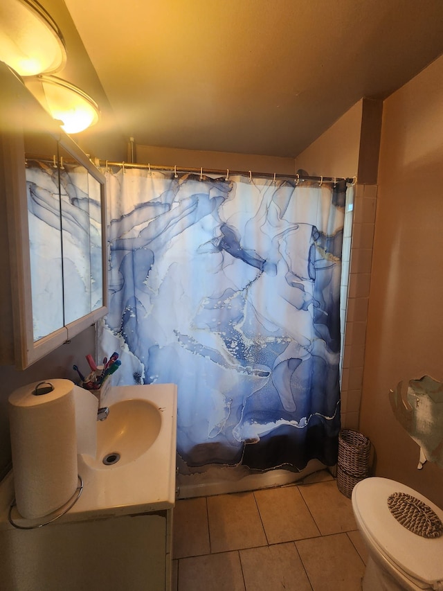 bathroom featuring tile patterned floors, vanity, toilet, and walk in shower