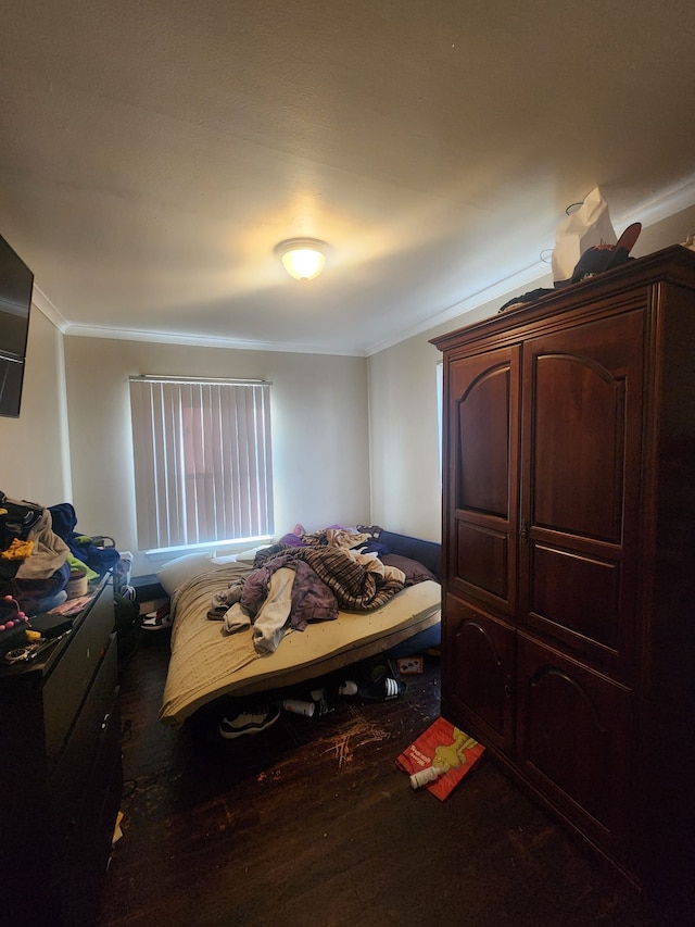 bedroom featuring hardwood / wood-style floors and ornamental molding