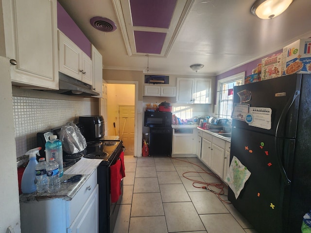 kitchen featuring black appliances, crown molding, sink, light tile patterned floors, and white cabinetry