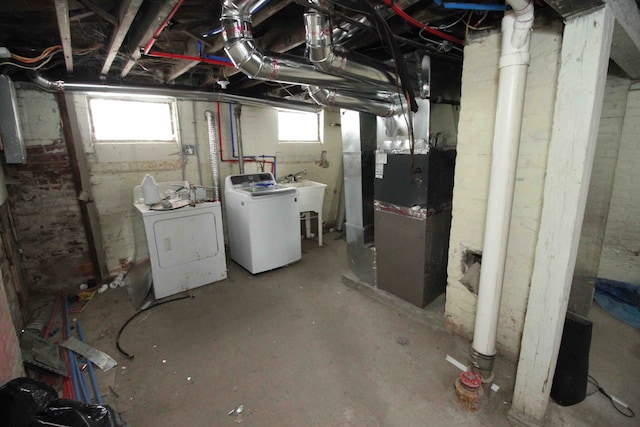 basement with washing machine and dryer and heating unit