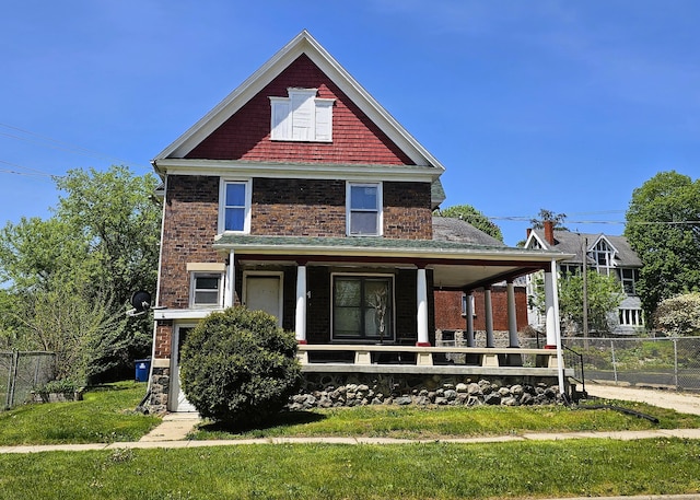 view of front of home with a porch and a front lawn