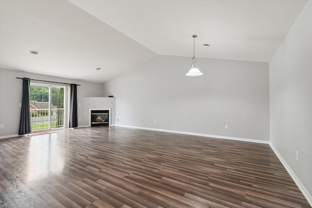 unfurnished living room with dark hardwood / wood-style flooring and vaulted ceiling