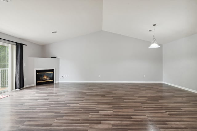 unfurnished living room with vaulted ceiling and dark hardwood / wood-style floors