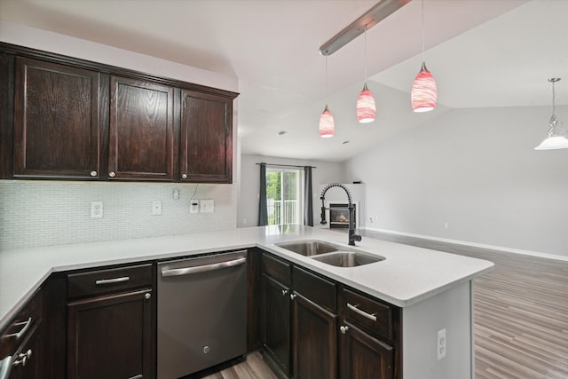 kitchen with sink, hanging light fixtures, stainless steel dishwasher, light hardwood / wood-style floors, and kitchen peninsula