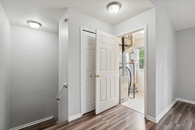 hallway with hardwood / wood-style flooring