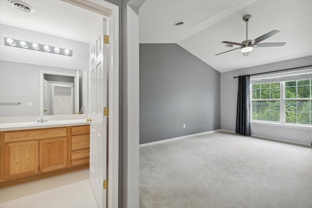 bathroom featuring vanity, ceiling fan, and lofted ceiling