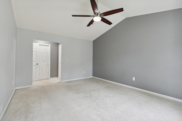 carpeted empty room with ceiling fan and vaulted ceiling