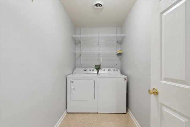 washroom with washing machine and dryer and light tile patterned floors