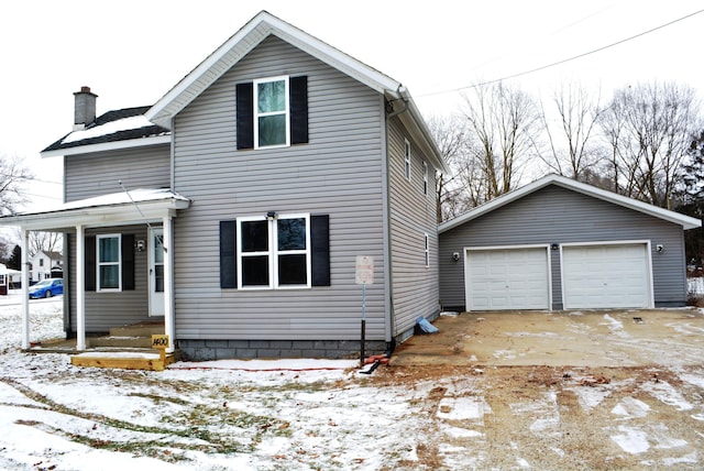 front of property featuring a garage and an outdoor structure