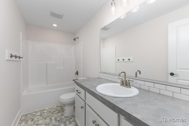 full bath with recessed lighting, vanity, washtub / shower combination, and toilet