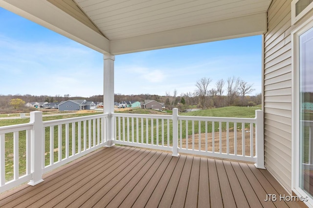 wooden deck featuring a lawn