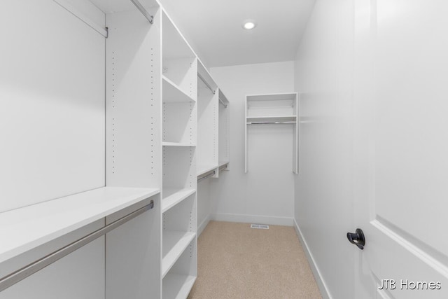 walk in closet with light carpet and visible vents