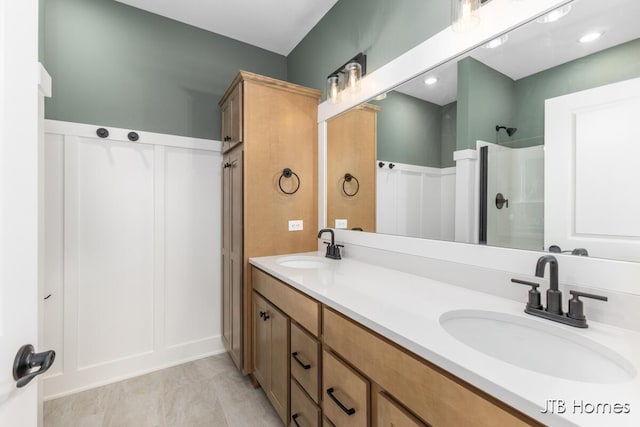 full bath with double vanity, a sink, and a shower