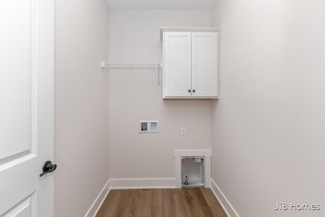 clothes washing area with cabinet space, washer hookup, baseboards, electric dryer hookup, and wood finished floors