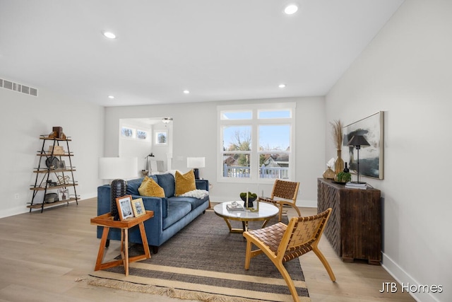 living area with recessed lighting, visible vents, baseboards, and light wood-style floors