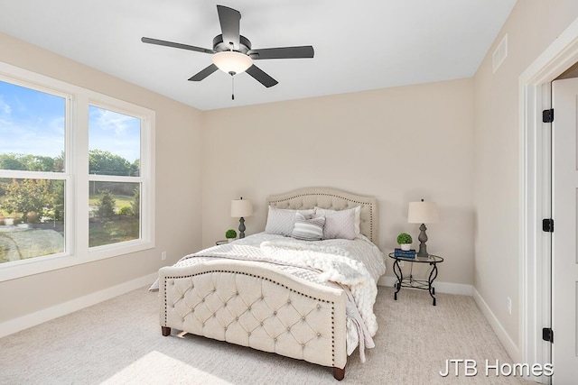 carpeted bedroom featuring visible vents, a ceiling fan, and baseboards