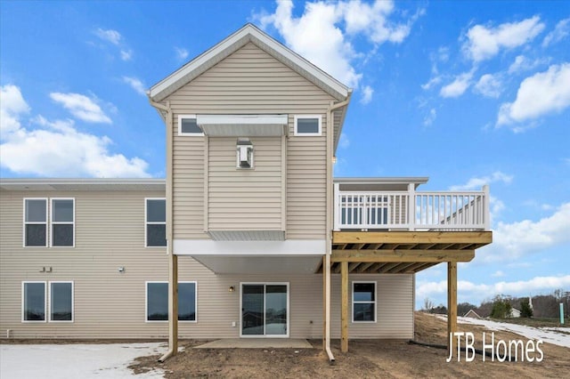 rear view of house featuring a deck and a patio