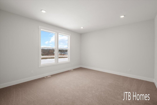 carpeted empty room featuring visible vents, recessed lighting, and baseboards