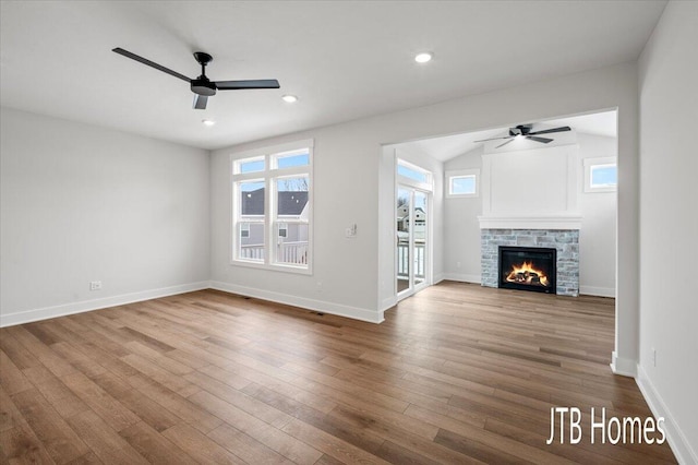 unfurnished living room featuring recessed lighting, baseboards, wood finished floors, and a ceiling fan