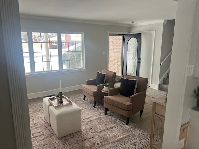 sitting room with hardwood / wood-style floors and ornamental molding