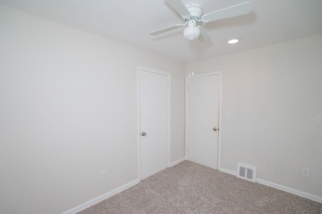 spare room with ceiling fan and carpet floors