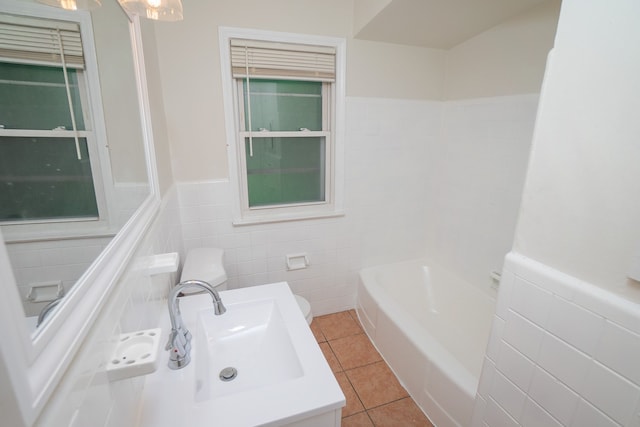 bathroom featuring vanity, tile patterned flooring, toilet, tile walls, and a tub